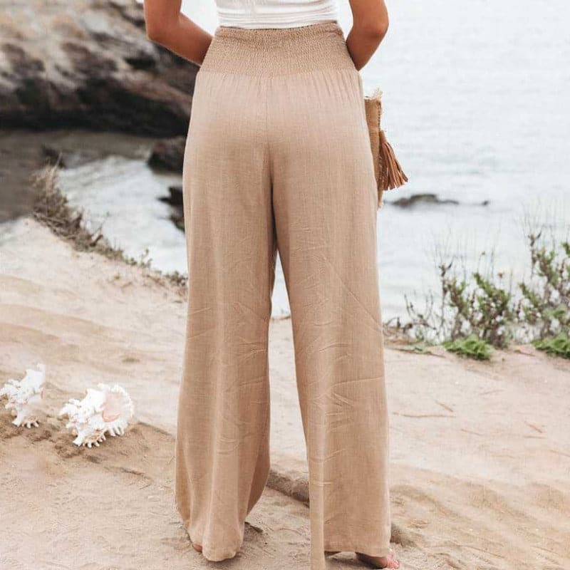 High-waisted linen wide-leg trousers with elastic smocked waistband, light tan