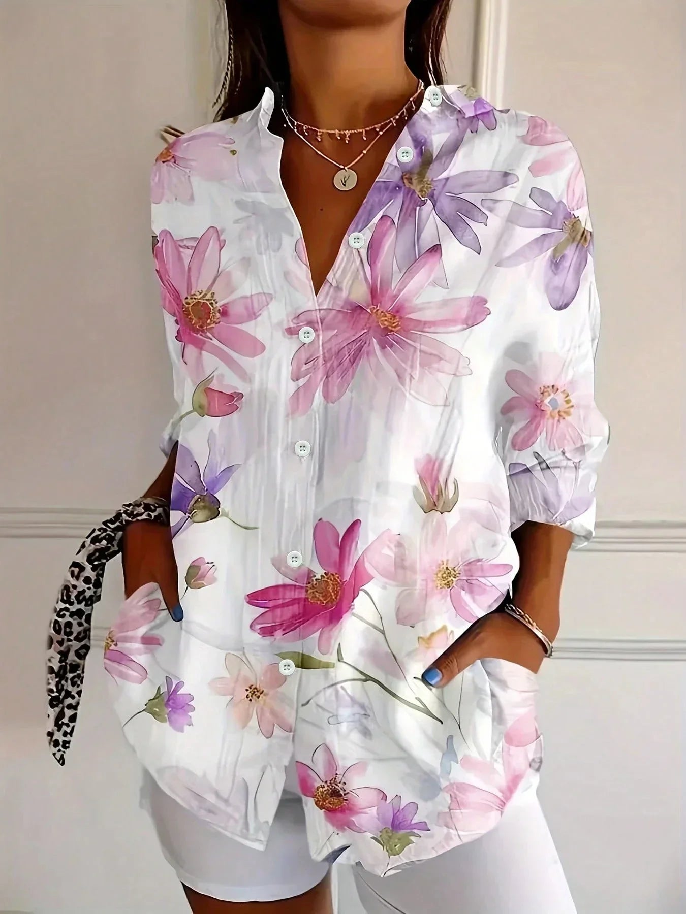 White floral abstract button-up blouse with collared neck, long sleeves, front buttons