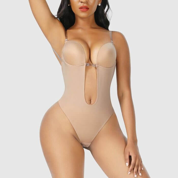 Beige backless body shaper with underwire cups and open back, hook-and-eye closure