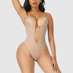 Beige backless body shaper with underwire cups and open back, hook-and-eye closure