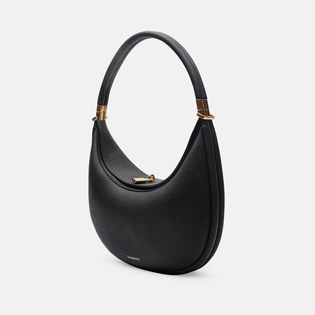 Black leather shoulder hobo bag with curved flap and gold-tone clasp