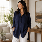 Women's dark blue button-front blouse with turn-down collar, rolled cuffs, curved hem