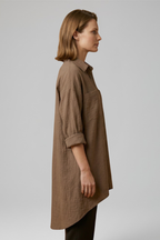 Brown women’s blouse with collar and button front, three-quarter sleeves, side view.