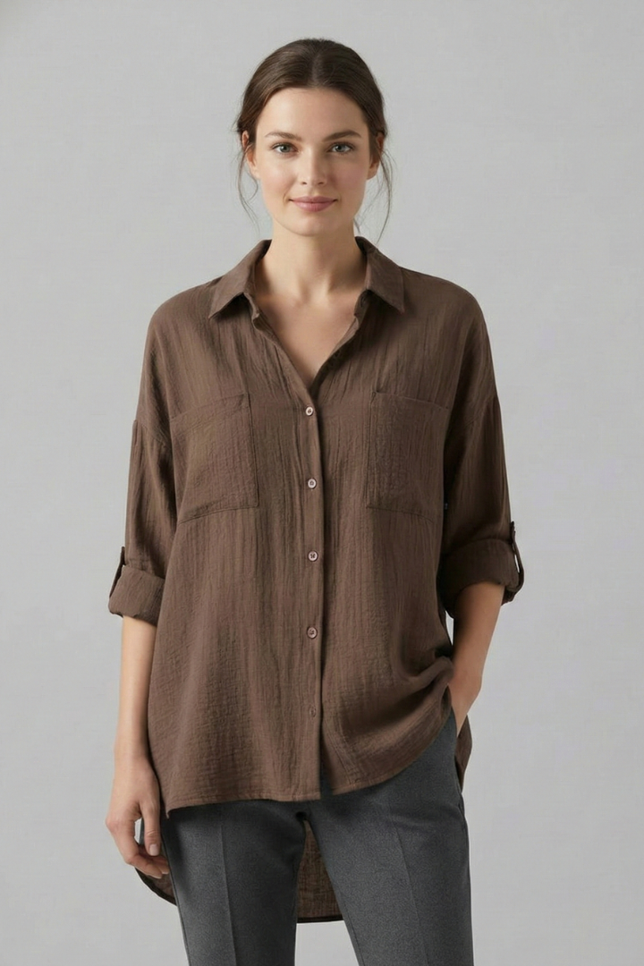 Brown women’s blouse with collar, button front, and chest pockets, three-quarter sleeves.
