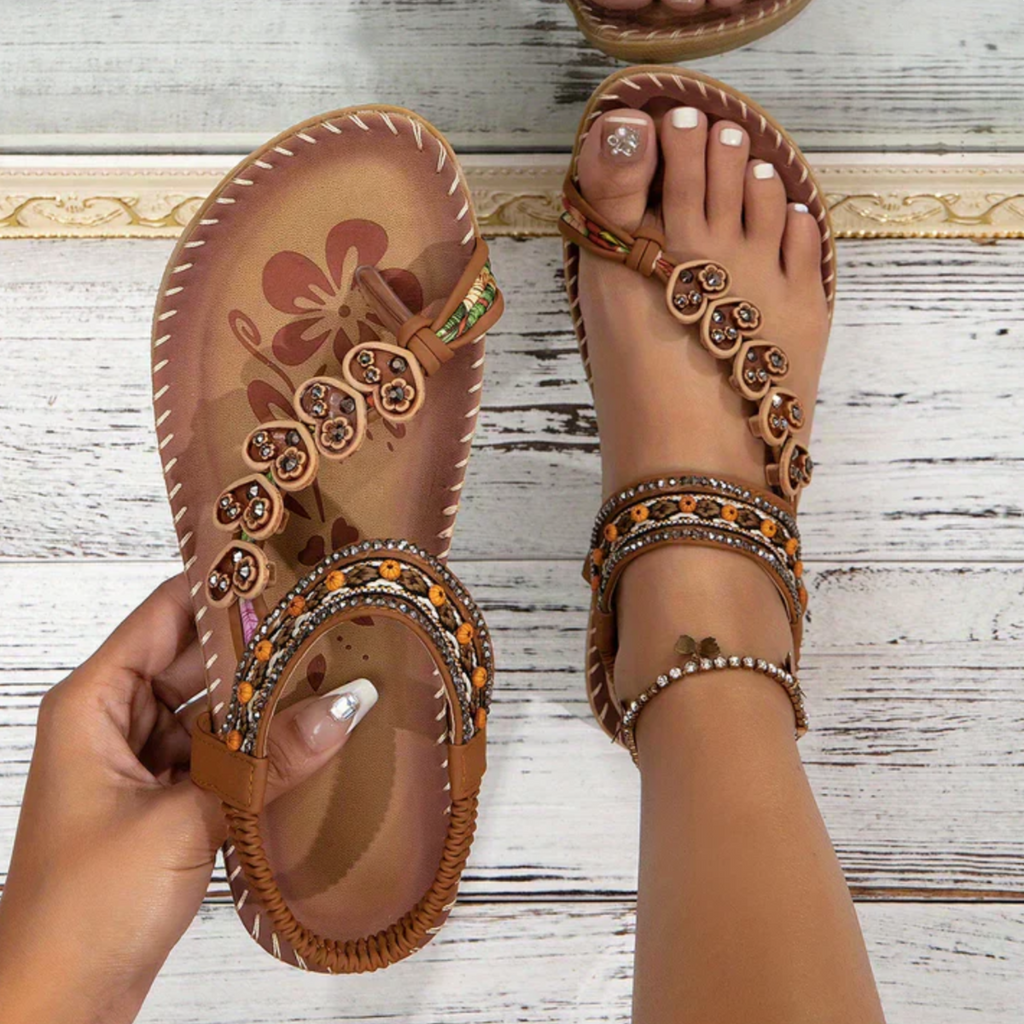 Brown flat open-toe sandals with side beaded embellishments and floral stitched toe