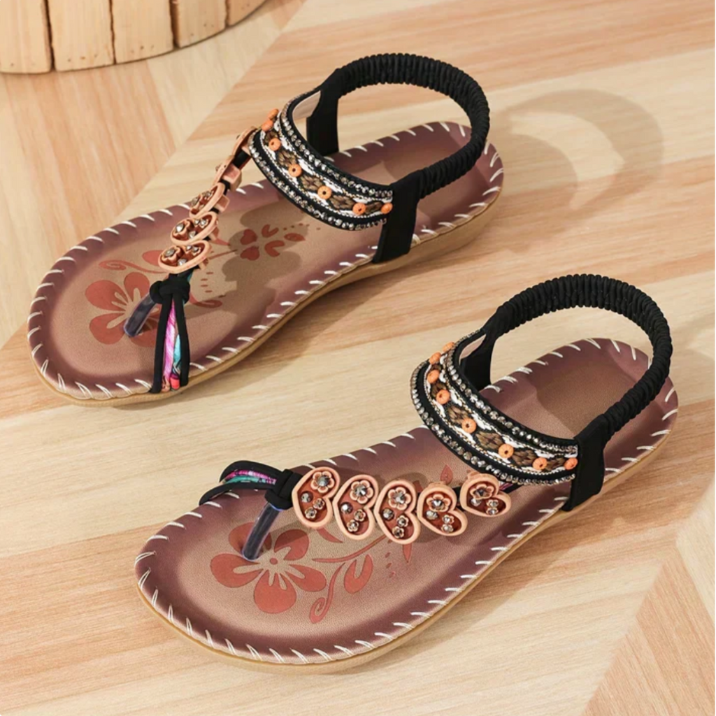 Navy thong flat sandals with beaded ankle strap and gold-toned floral charm row