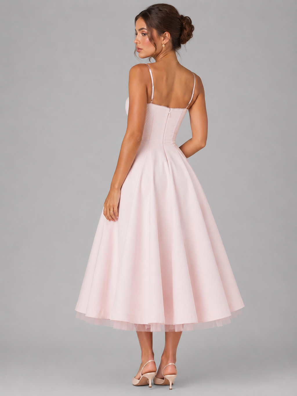 Pink corset midi dress, thin back straps and full flared skirt in a rear view.