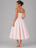 Pink corset midi dress, thin back straps and full flared skirt in a rear view.