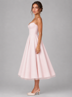 Pale pink corset bodice midi dress with sweetheart neckline and full flared skirt.