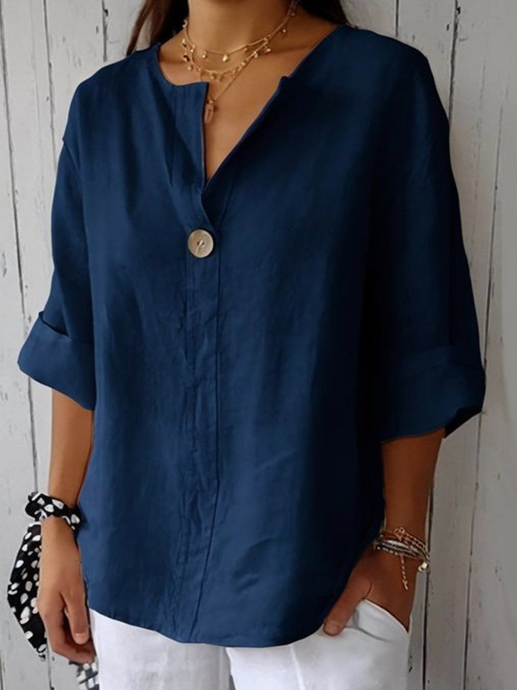 Navy blue cotton V-neck blouse with single front button and three-quarter sleeves