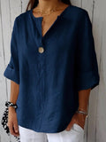 Navy blue cotton V-neck blouse with single front button and three-quarter sleeves