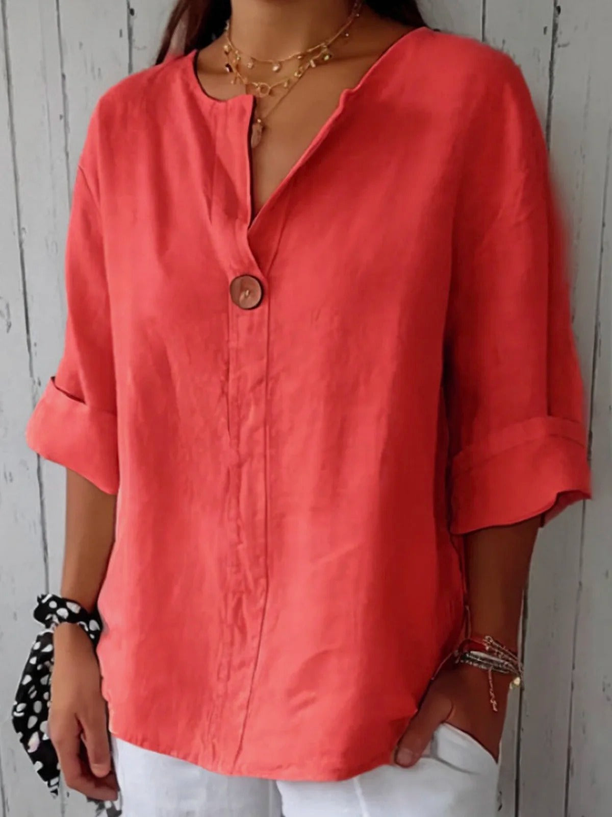 Red cotton V-neck blouse with single front button and three-quarter sleeves