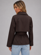 Back view: cropped dark brown trench jacket with tie waist and button details