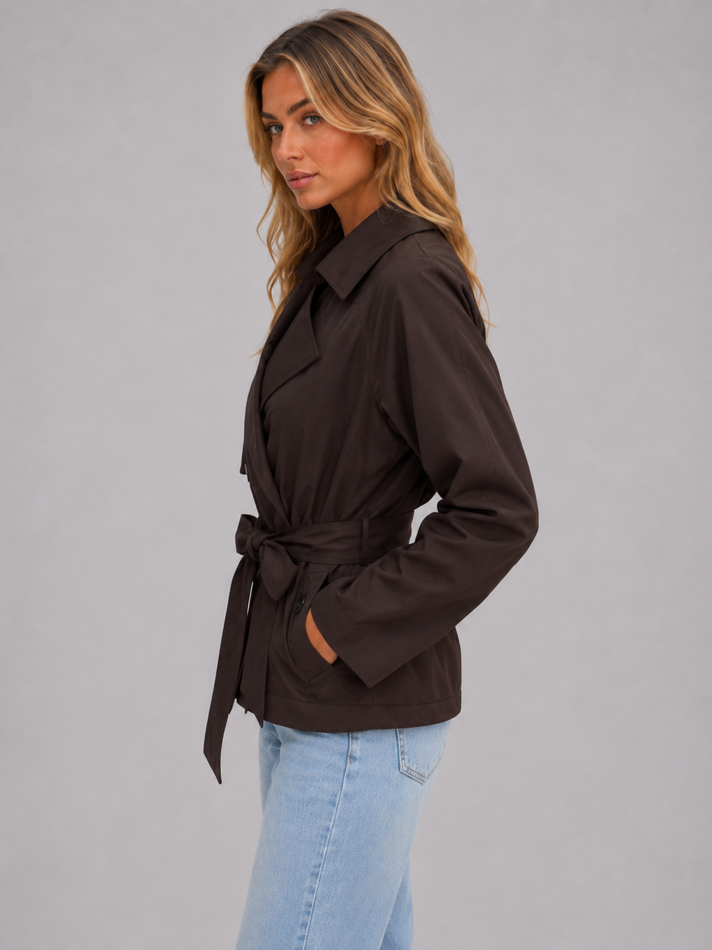 Cropped dark brown trench jacket with tie belt, side view, buttoned sleeves