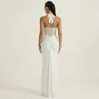 White halter-neck maxi dress, open back with tie bow and ruched fitted skirt