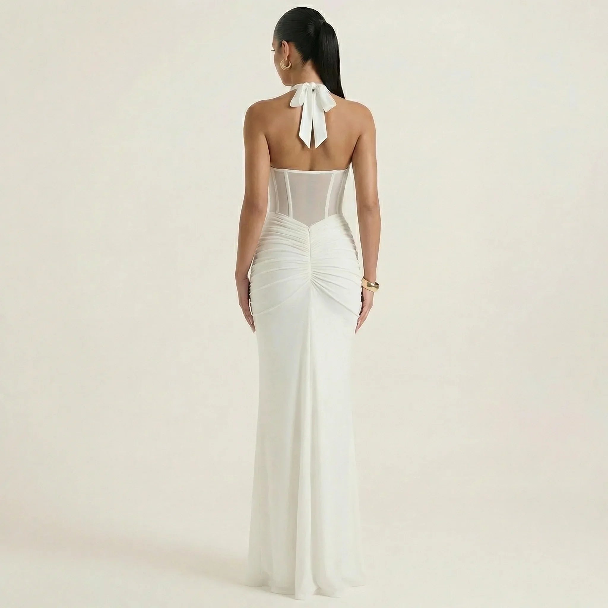 White halter-neck maxi dress, open back with tie bow and ruched fitted skirt