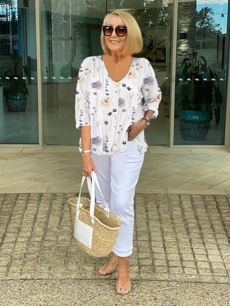 Women’s white floral V-neck blouse with 3/4 sleeves and button-front placket