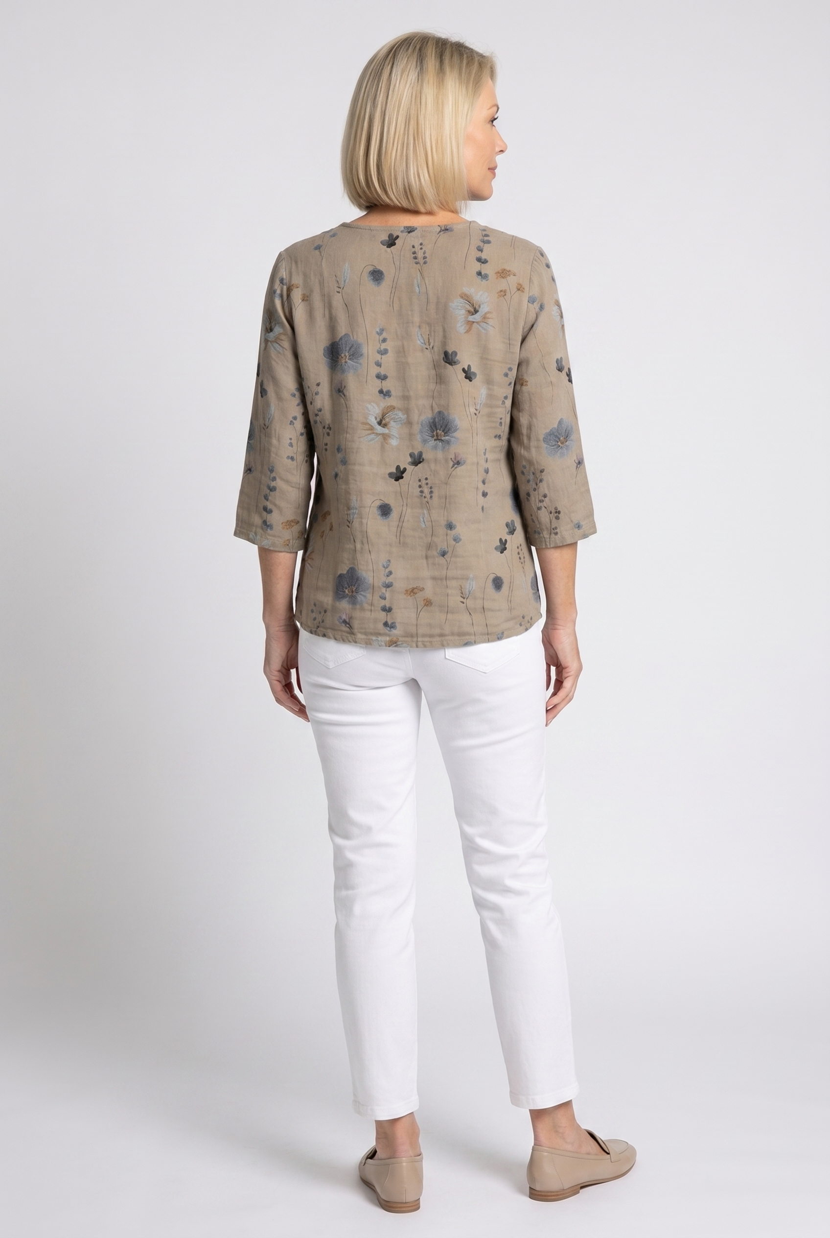 Women’s taupe floral V-neck blouse shown from back with 3/4 sleeves