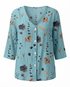 Women’s teal floral V-neck blouse with 3/4 sleeves and button-front placket