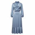 Light blue satin midi dress with long sleeves and high neck, side view.