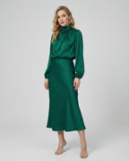 Deep green satin midi dress with long sleeves and high neckline, standing front view.