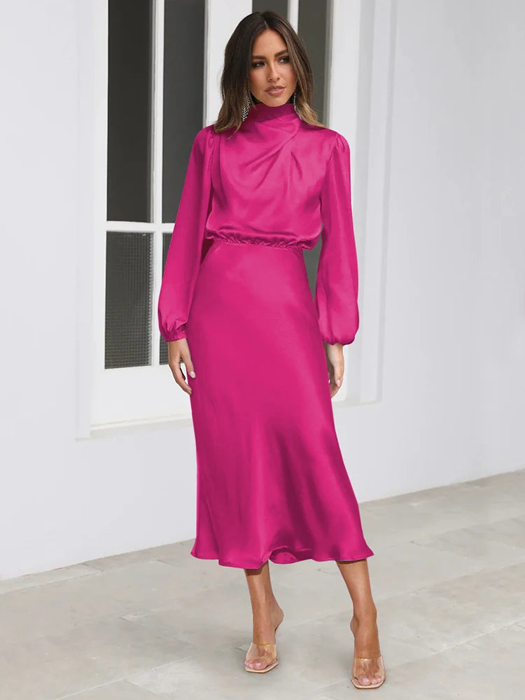 Pink satin midi dress with long balloon sleeves and high neck, full-length view.