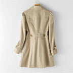 Beige trench coat back view, belt with buckle, buttoned sleeve tabs