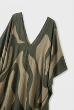 Olive-green oversized kaftan maxi dress with deep V-neck and abstract beige leaf print