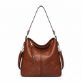 Large crossbody zip bag in tan-brown with adjustable strap, top zipper, and zip compartments