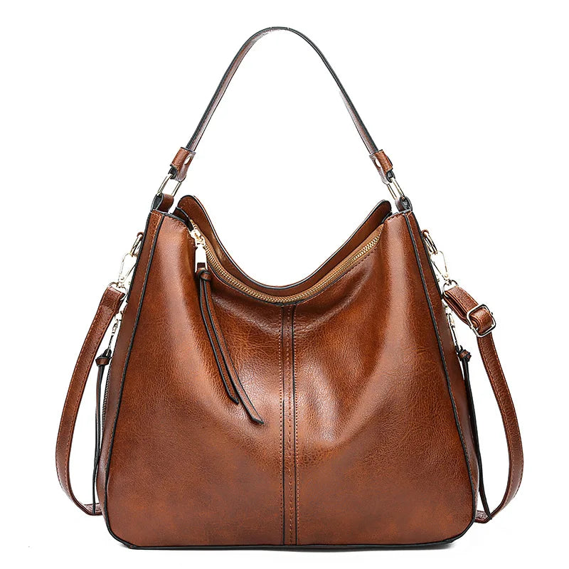Large crossbody zip bag in brown with adjustable strap, top zipper, and zip compartments