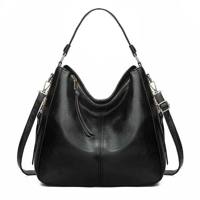 Large crossbody zip bag in black with adjustable strap, top zipper, and zip compartments