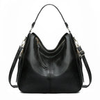 Large crossbody zip bag in black with adjustable strap, top zipper, and zip compartments