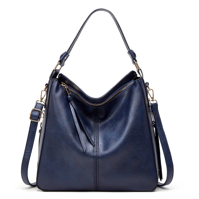 Large crossbody zip bag in blue with adjustable strap, top zipper, and zip compartments