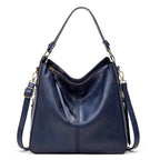 Large crossbody zip bag in blue with adjustable strap, top zipper, and zip compartments