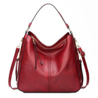Large crossbody zip bag in red with adjustable strap, top zipper, and zip compartments