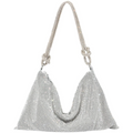 Silver glitter shoulder bag with short chain handles and curved top opening.