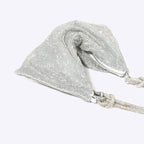 Silver glitter shoulder bag detail view with chain strap and clasp hardware.