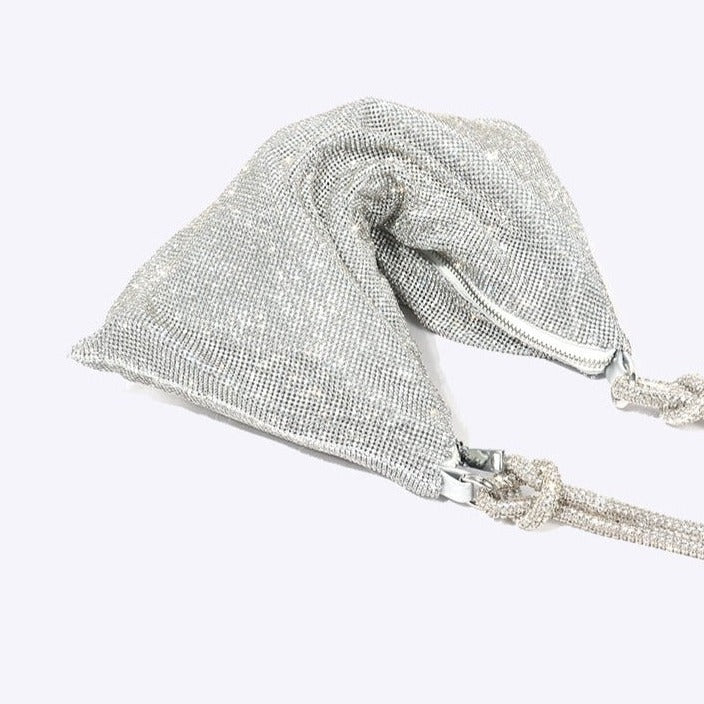 Silver glitter shoulder bag detail view with chain strap and clasp hardware.