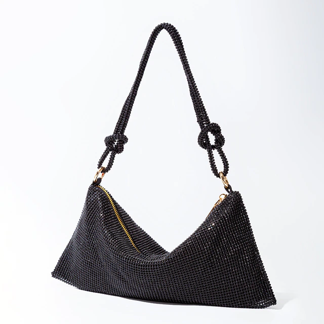 Black glitter shoulder bag with chain handles and curved front seam.