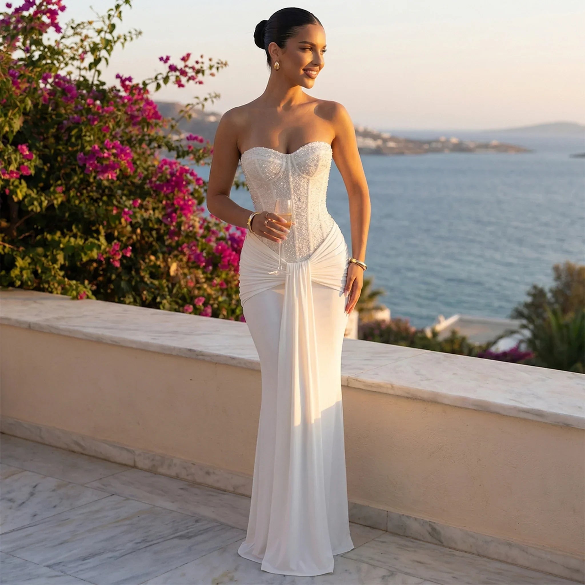 White strapless sequin maxi evening gown with fitted waist ruching and flowing skirt