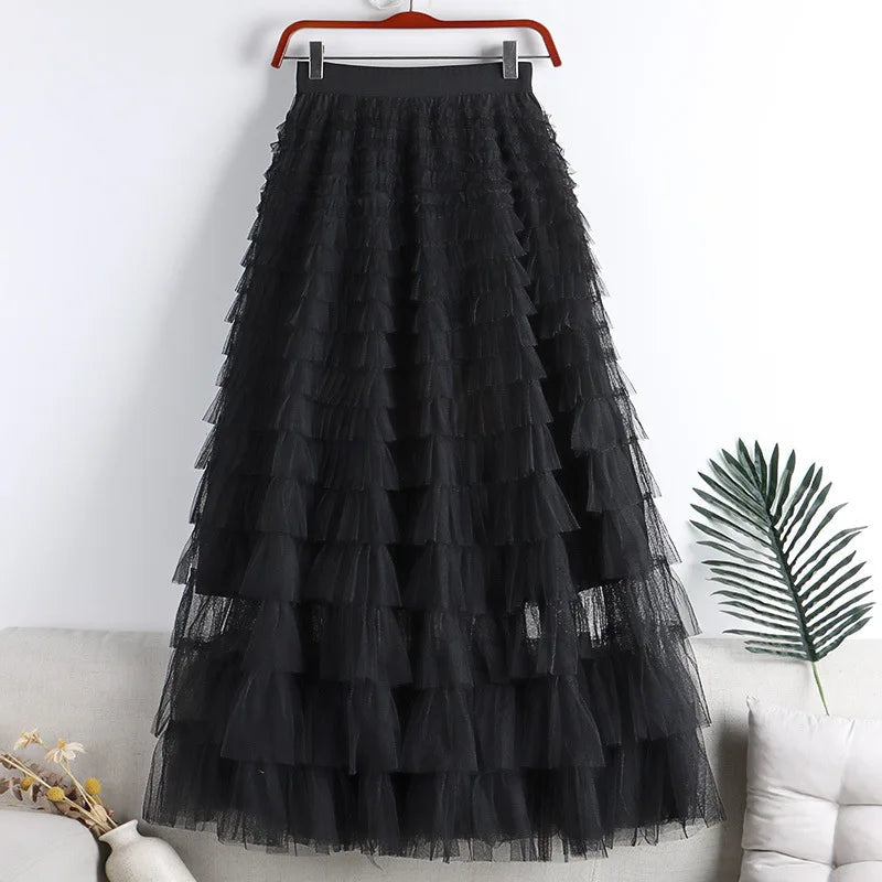 Black tiered tulle maxi skirt with ruffle layers, hanging on a hanger