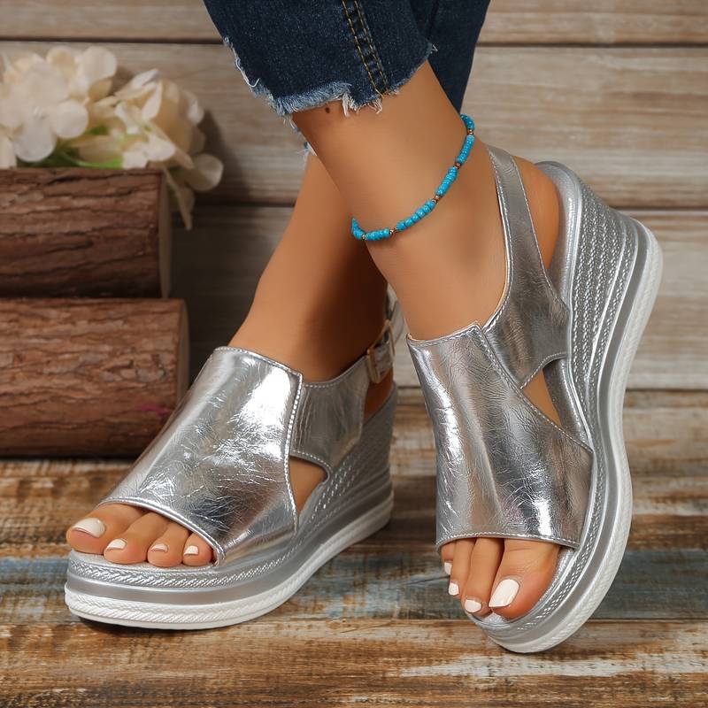 Silver metallic peep-toe wedge platform sandals with cutout upper and ankle strap