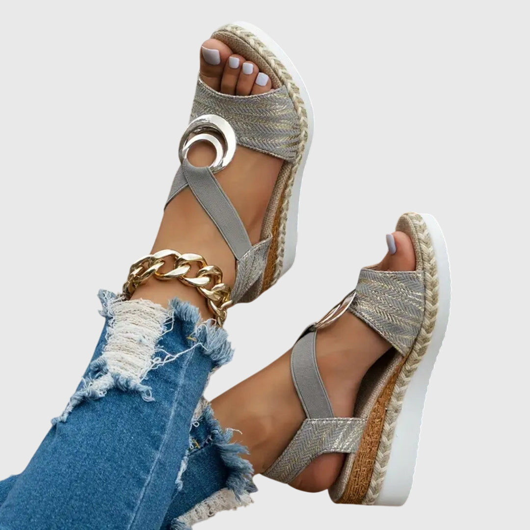 Gray espadrille platform sandals with open toe, gold ring detail and crisscross straps