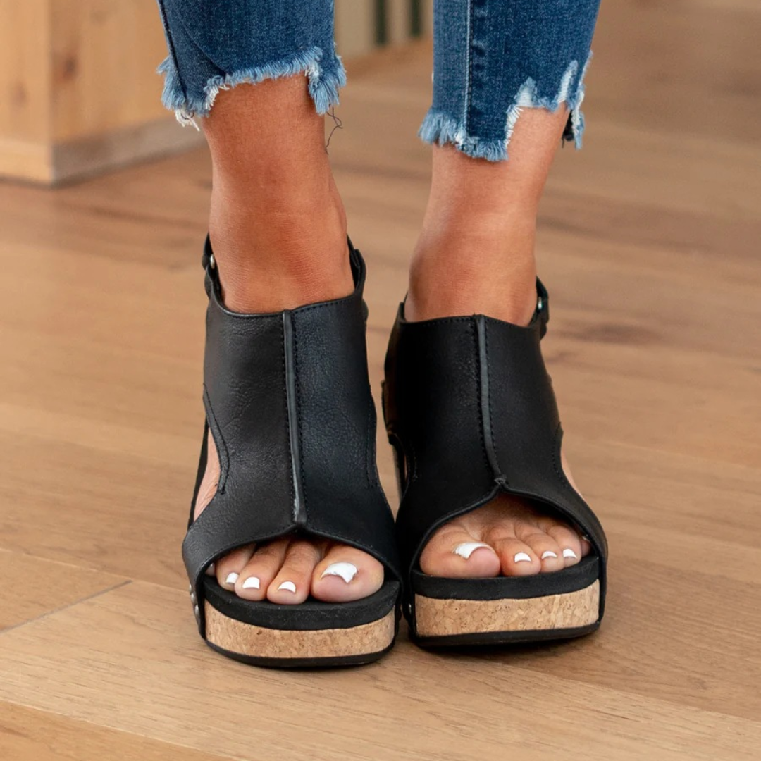 Black studded platform wedge sandals with open toe and slingback ankle strap