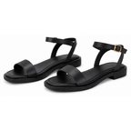 Pair of women's black flat sandals with ankle straps and gold buckle details