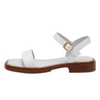 Women's white ankle-strap flat sandals with wide toe strap and gold buckle