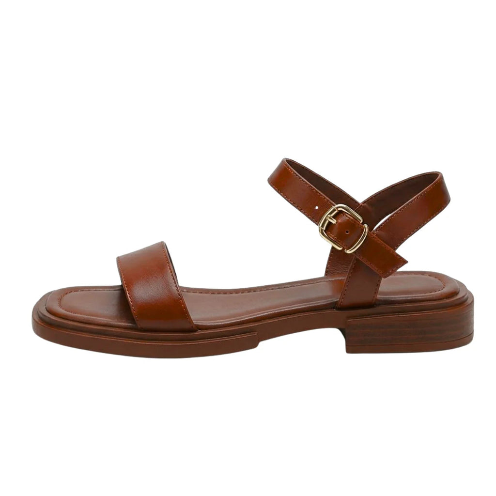Women's brown ankle-strap flat sandals with wide toe strap and gold buckle