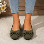 Wide-fit cushioned ballet flats, dark green faux suede, bow at toe, on feet