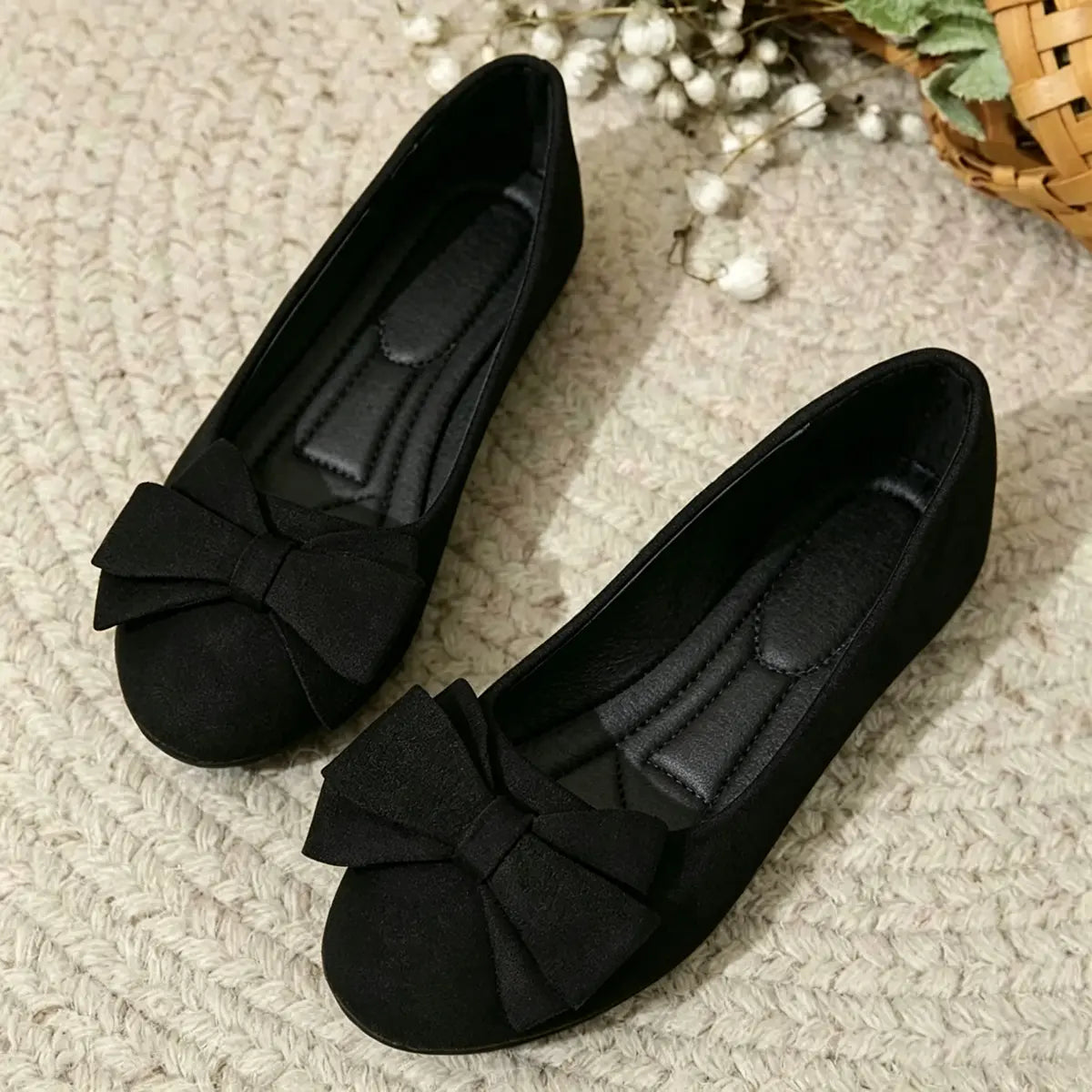 Wide-fit cushioned ballet flats, black faux suede, bow detail, pair on rug