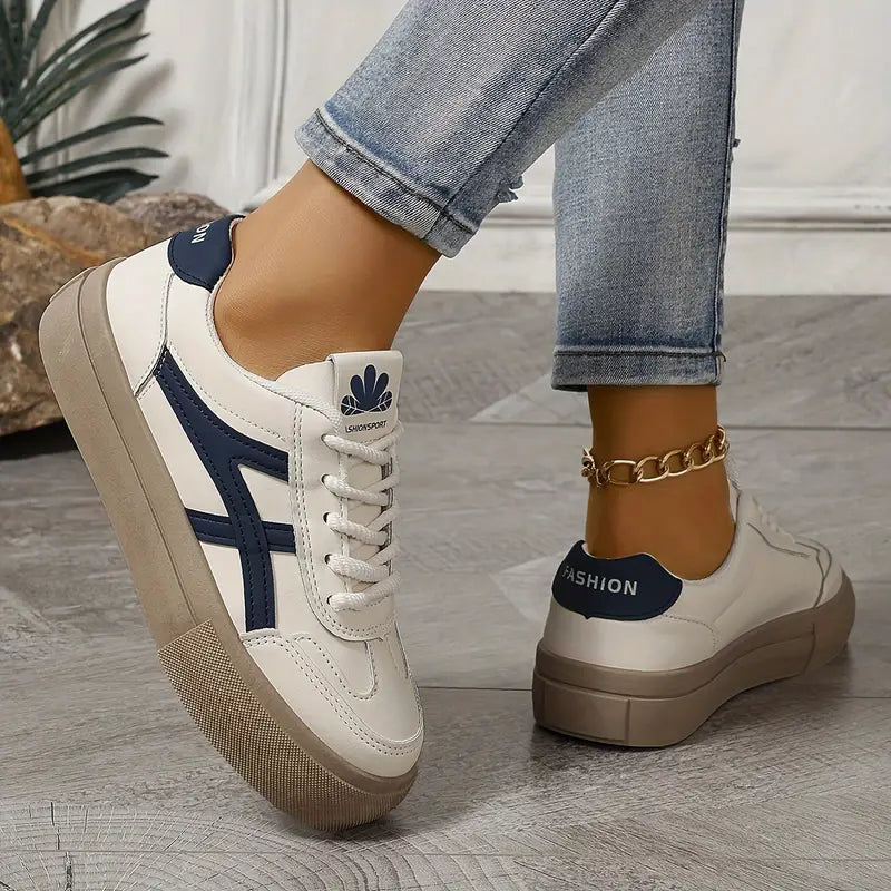 Women’s white platform sneakers with navy side stripes, lace-up, and tan heel platform